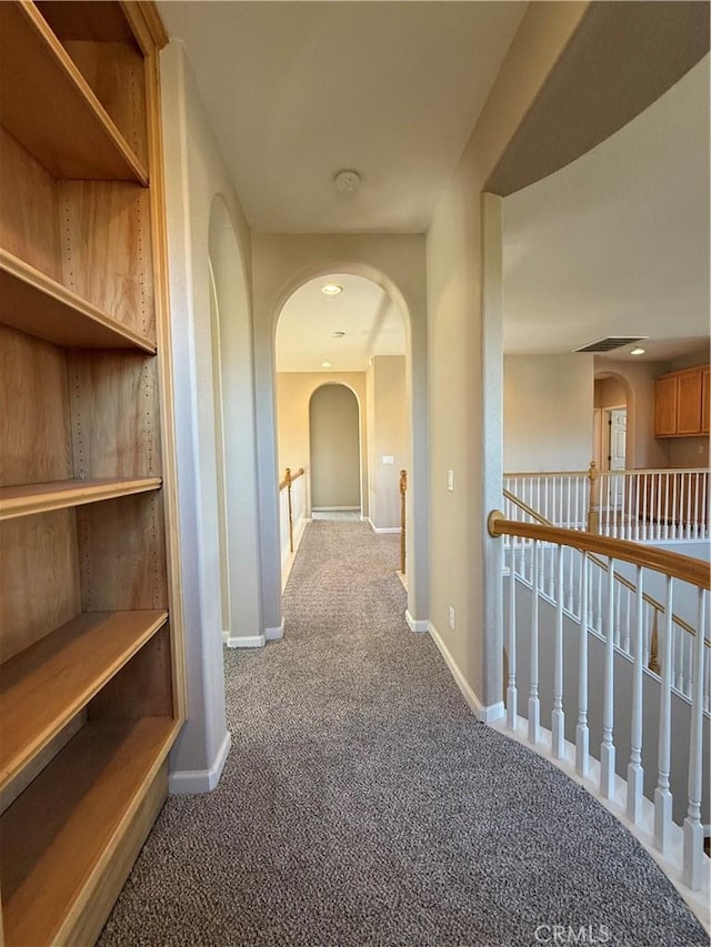 4125 Sattui Ct, Merced, CA 95348 - hallway featuring carpet flooring, arched walkways, and an upstairs landing