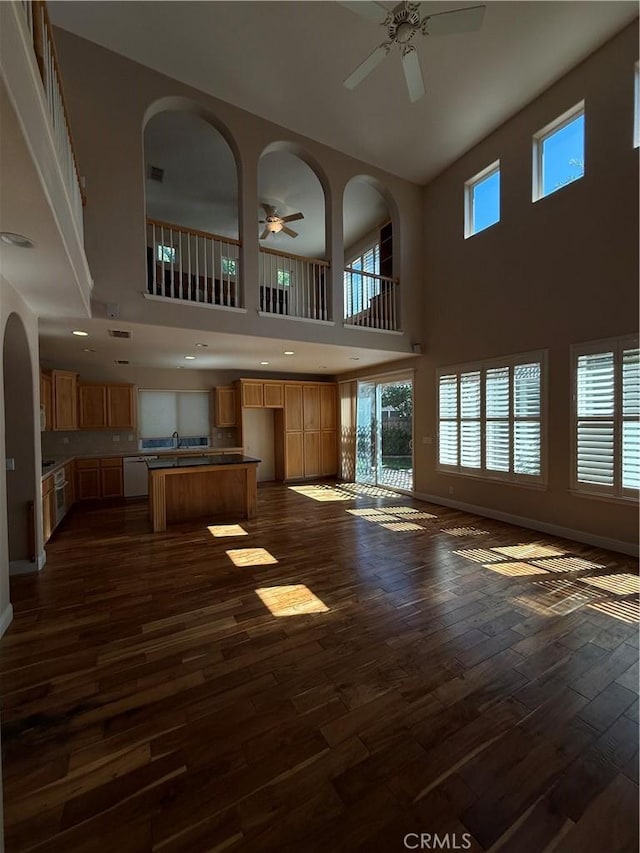 4125 Sattui Ct, Merced, CA 95348 - unfurnished living room with a ceiling fan, dark wood-style floors, and a high ceiling