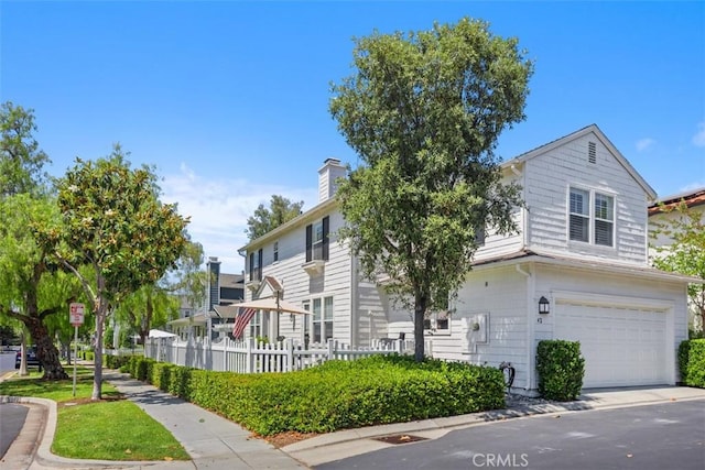 42 Livingston Pl, Ladera Ranch, CA 92694 - view of front facade featuring an attached garage, a chimney, and driveway