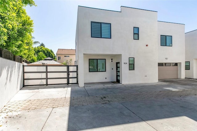 9124 N Nilo Ln, Panorama City, CA 91402 - contemporary house featuring stucco siding, a gate, and a garage