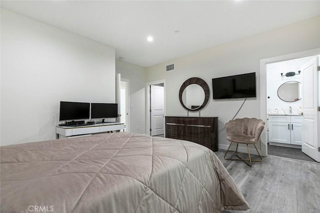 9124 N Nilo Ln, Panorama City, CA 91402 - bedroom featuring wood finished floors, recessed lighting, and ensuite bath