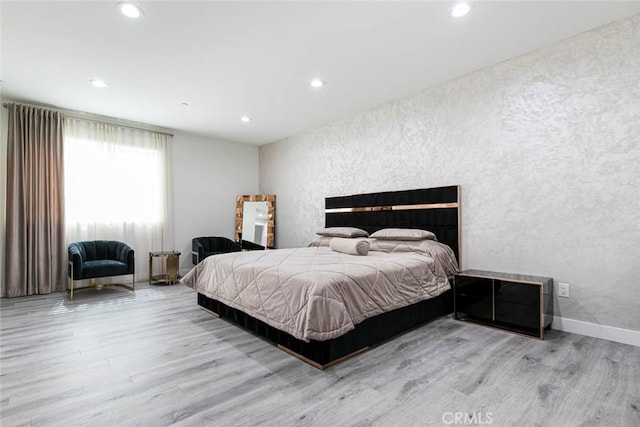 9124 N Nilo Ln, Panorama City, CA 91402 - bedroom featuring wood finished floors, a textured wall, and recessed lighting
