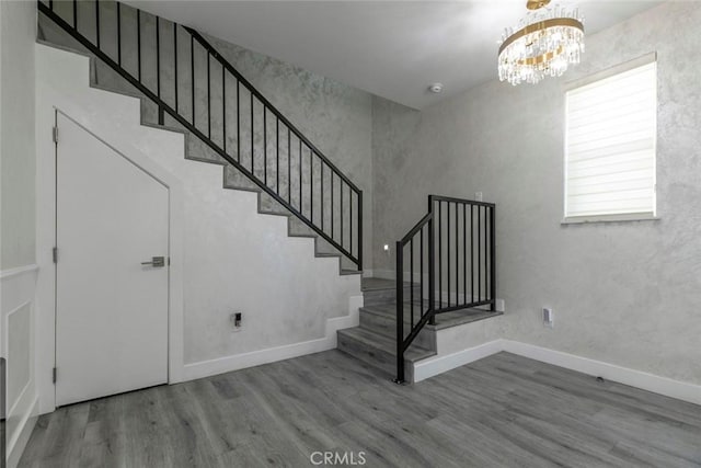 9124 N Nilo Ln, Panorama City, CA 91402 - stairway with wood finished floors and a chandelier