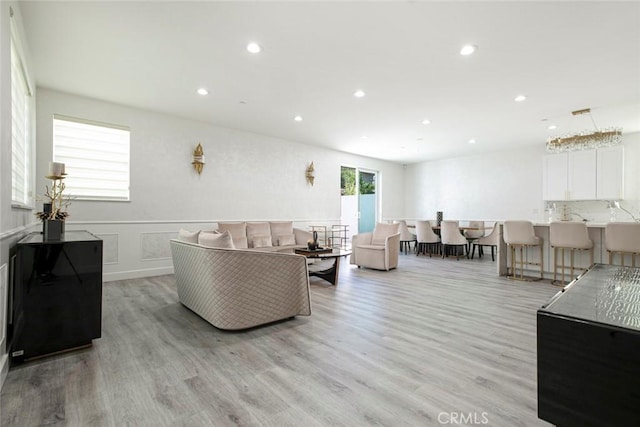 9124 N Nilo Ln, Panorama City, CA 91402 - living room featuring recessed lighting, light wood finished floors, and a wainscoted wall