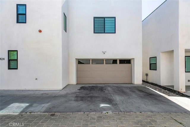 9124 N Nilo Ln, Panorama City, CA 91402 - view of front facade featuring a garage, stucco siding, and driveway