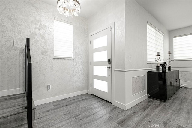 9124 N Nilo Ln, Panorama City, CA 91402 - entrance foyer featuring wood finished floors, a chandelier, and a textured wall