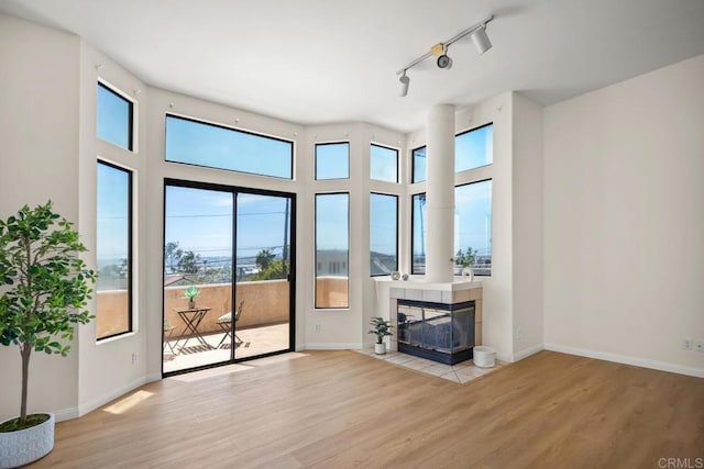 3531 Columbia St, San Diego, CA 92103 - unfurnished living room featuring wood finished floors, healthy amount of natural light, a tile fireplace, and track lighting