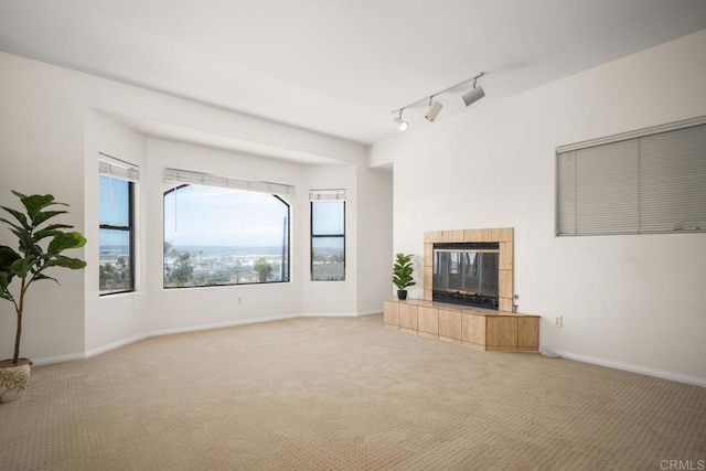 3531 Columbia St, San Diego, CA 92103 - unfurnished living room with carpet, track lighting, and a tiled fireplace
