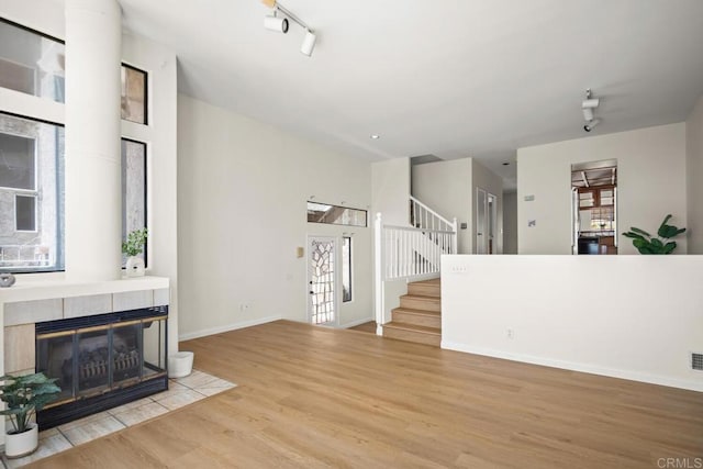 3531 Columbia St, San Diego, CA 92103 - unfurnished living room featuring wood finished floors, plenty of natural light, stairs, and a tiled fireplace
