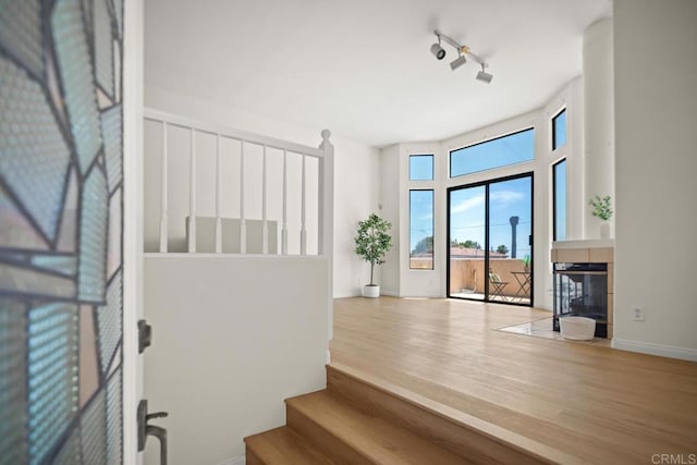 3531 Columbia St, San Diego, CA 92103 - foyer featuring wood finished floors, a fireplace, stairway, and rail lighting