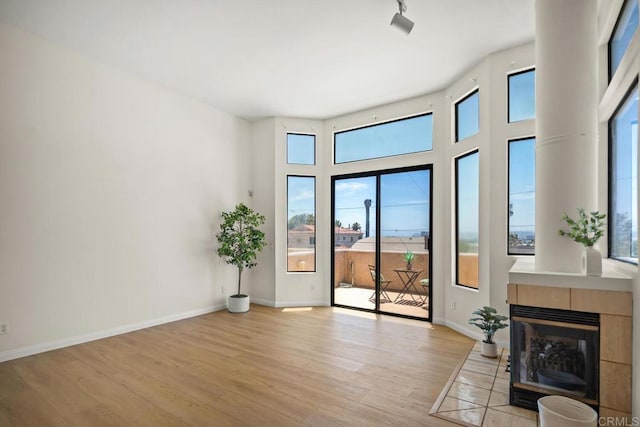 3531 Columbia St, San Diego, CA 92103 - living area featuring light wood-type flooring and a tiled fireplace