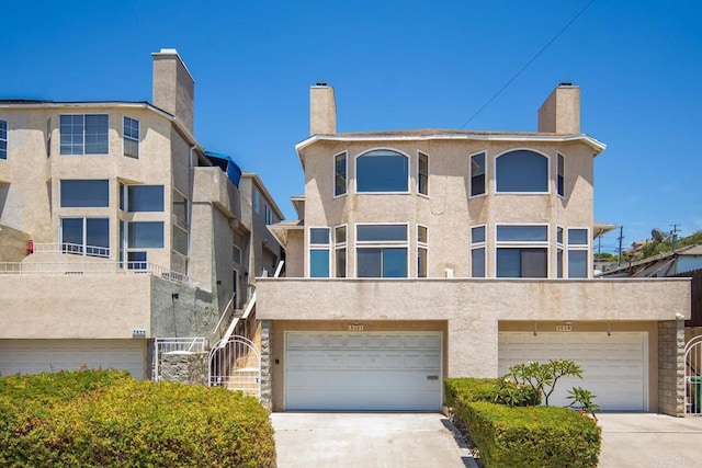 3531 Columbia St, San Diego, CA 92103 - back of property featuring driveway, an attached garage, and stucco siding