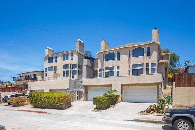 3531 Columbia St, San Diego, CA 92103 - view of front of house featuring a garage, driveway, stucco siding, and a chimney