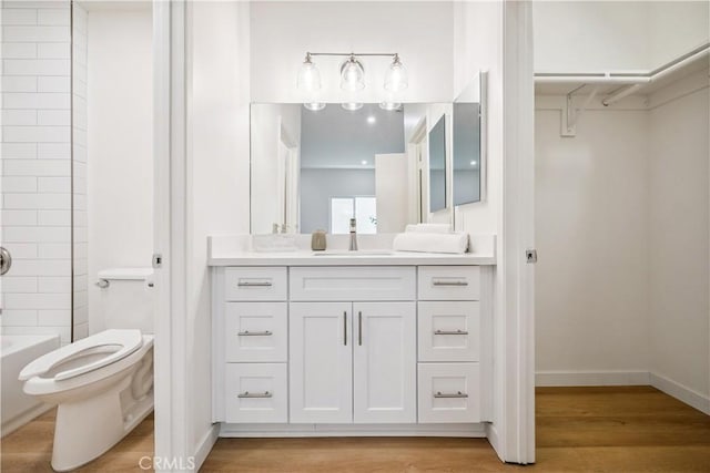 11722 Avon Way Unit 103, Los Angeles, CA 90066 - full bath featuring vanity, wood finished floors, a spacious closet, and tub / shower combination