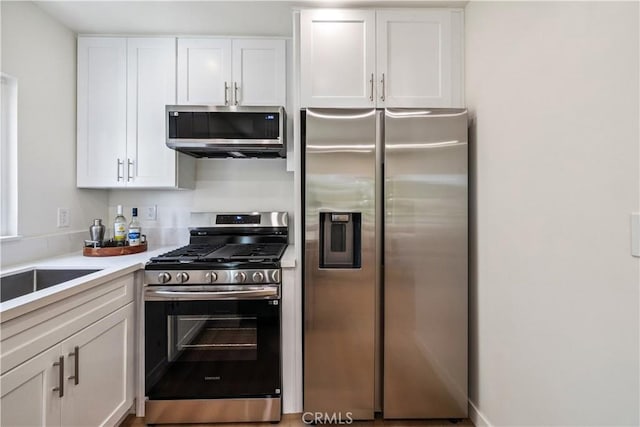 11722 Avon Way Unit 103, Los Angeles, CA 90066 - kitchen featuring stainless steel appliances, white cabinetry, and light countertops