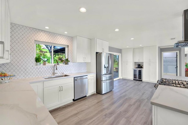 4710 Sleeping Indian Rd, Fallbrook, CA 92028 - kitchen with appliances with stainless steel finishes, wine cooler, light stone counters, white cabinets, and recessed lighting