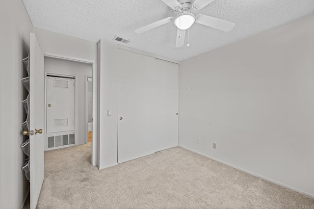 13292 Salmon River Rd Unit 204, San Diego, CA 92129 - unfurnished bedroom with light carpet, a textured ceiling, a closet, and ceiling fan