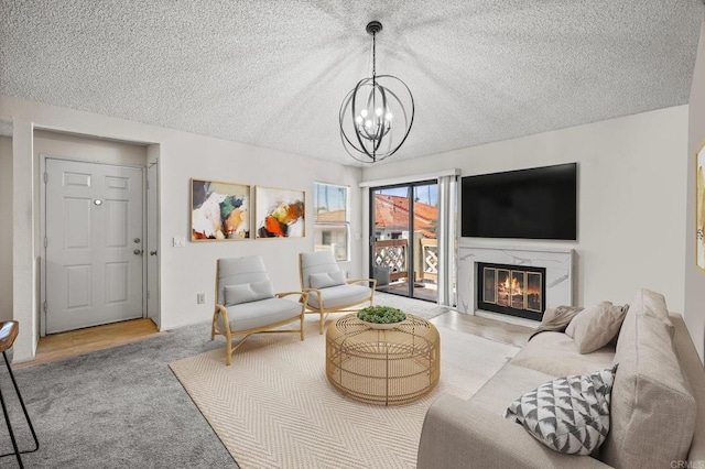 13292 Salmon River Rd Unit 204, San Diego, CA 92129 - carpeted living area with a textured ceiling, a chandelier, and a fireplace