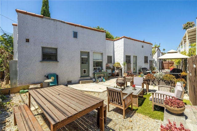 1928 Rosalia Rd, Los Angeles, CA 90027 - rear view of house featuring a patio area, stucco siding, outdoor lounge area, a gazebo, and outdoor dining area