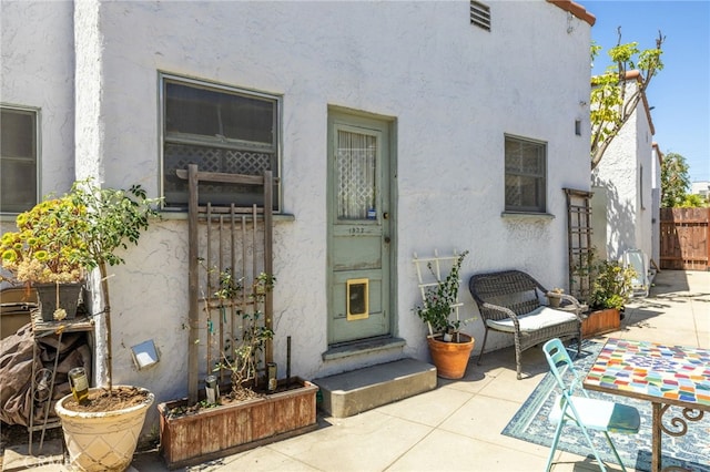 1928 Rosalia Rd, Los Angeles, CA 90027 - view of exterior entry with stucco siding and a patio area