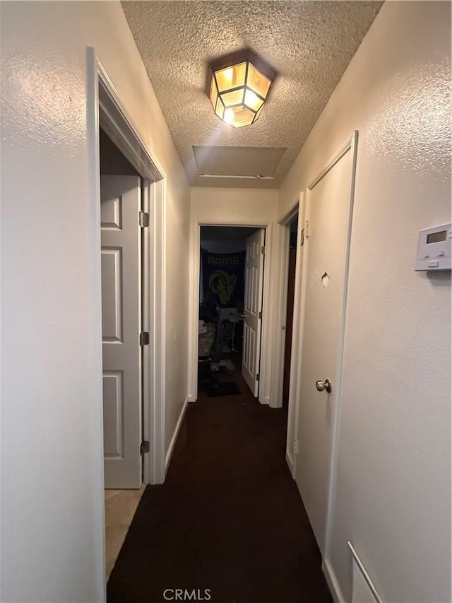 12490 Wolverine Cir, Moreno Valley, CA 92555 - hall featuring a textured ceiling, attic access, and carpet flooring