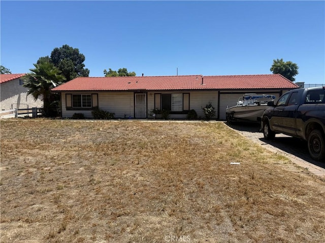 12490 Wolverine Cir, Moreno Valley, CA 92555 - ranch-style home featuring a garage and a tile roof