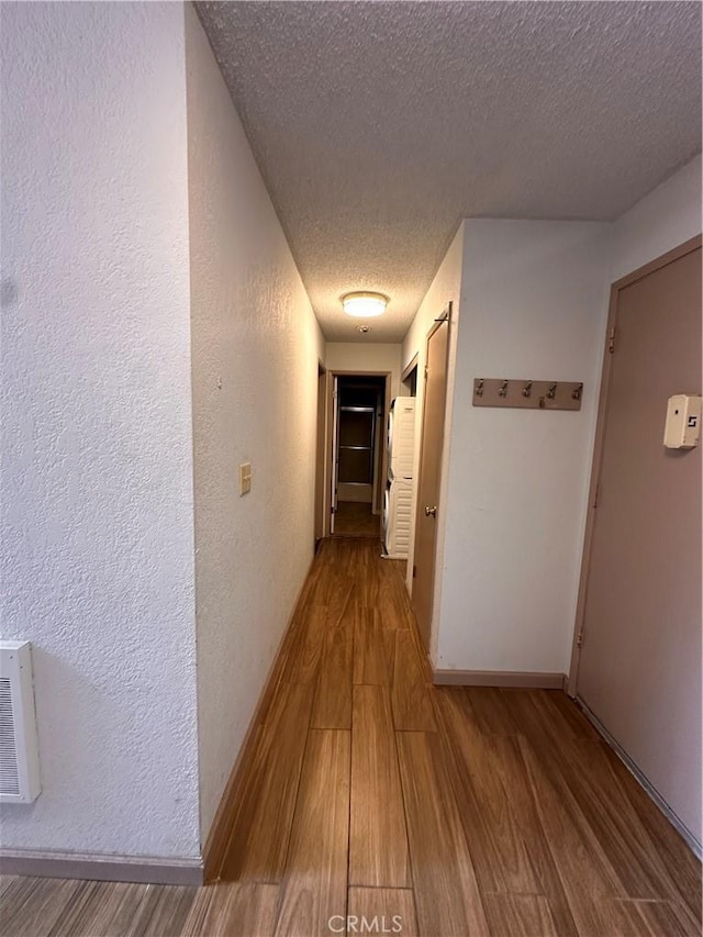 1 Appian Way Unit 710-6, South San Francisco, CA 94080 - hall with wood finished floors, a textured ceiling, and a textured wall