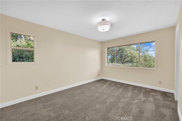 3777 N Arrowhead Ave, San Bernardino, CA 92405 - empty room with baseboards and dark carpet