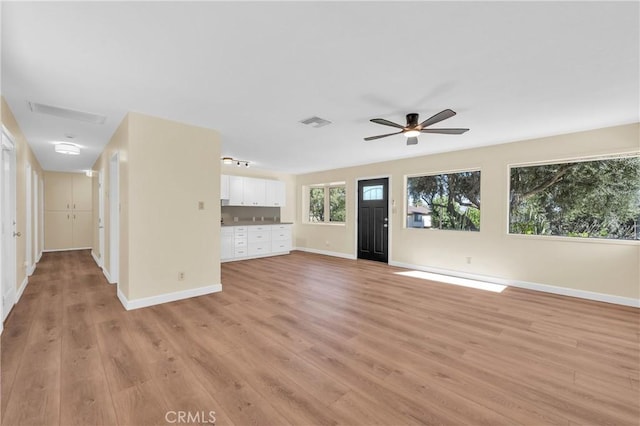 3777 N Arrowhead Ave, San Bernardino, CA 92405 - unfurnished living room with light wood finished floors and a ceiling fan