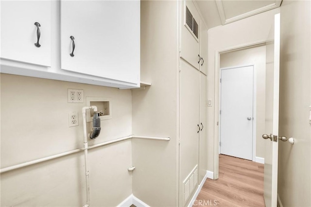 3777 N Arrowhead Ave, San Bernardino, CA 92405 - laundry area with cabinet space, light wood finished floors, and hookup for a washing machine