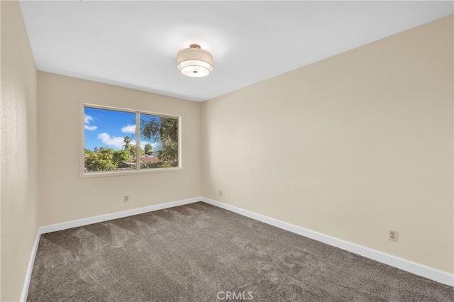 3777 N Arrowhead Ave, San Bernardino, CA 92405 - empty room featuring dark colored carpet and baseboards