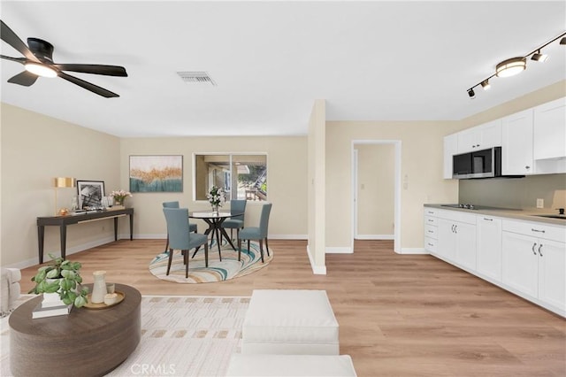 3777 N Arrowhead Ave, San Bernardino, CA 92405 - living area with light wood finished floors and a ceiling fan