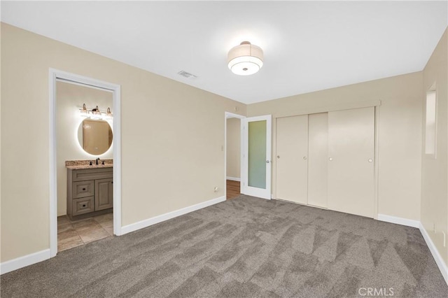 3777 N Arrowhead Ave, San Bernardino, CA 92405 - unfurnished bedroom featuring carpet, a closet, and connected bathroom