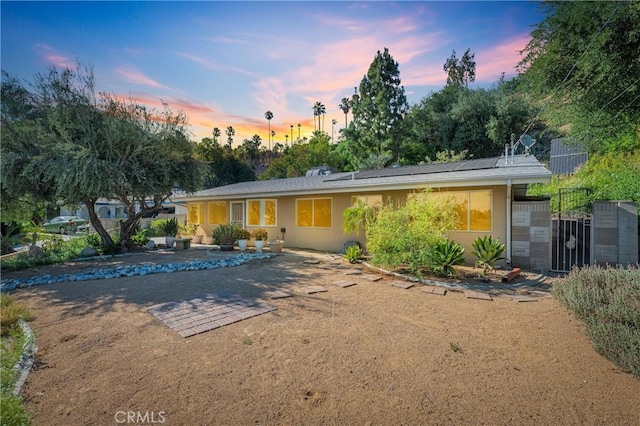 3777 N Arrowhead Ave, San Bernardino, CA 92405 - back of house with stucco siding, a patio, and solar panels