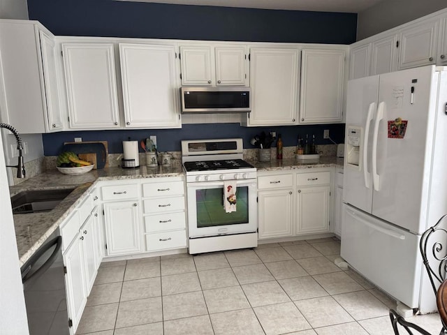 625 Sumner Way Unit 2, Oceanside, CA 92058 - kitchen featuring white appliances, light stone counters, and white cabinetry