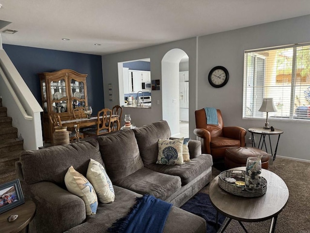 625 Sumner Way Unit 2, Oceanside, CA 92058 - living area with arched walkways, carpet flooring, and stairway