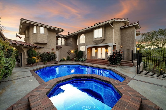 23511 Mirage Ln, Diamond Bar, CA 91765 - rear view of property with french doors, stucco siding, a patio, a pool with connected hot tub, and a balcony