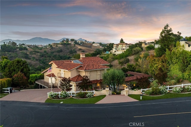 23511 Mirage Ln, Diamond Bar, CA 91765 - mediterranean / spanish-style home with stucco siding, driveway, a mountain view, and a tile roof