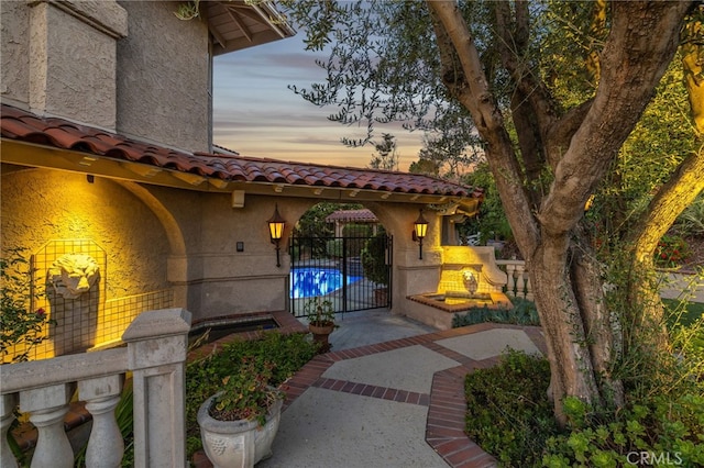 23511 Mirage Ln, Diamond Bar, CA 91765 - exterior entry at dusk with a tile roof and stucco siding
