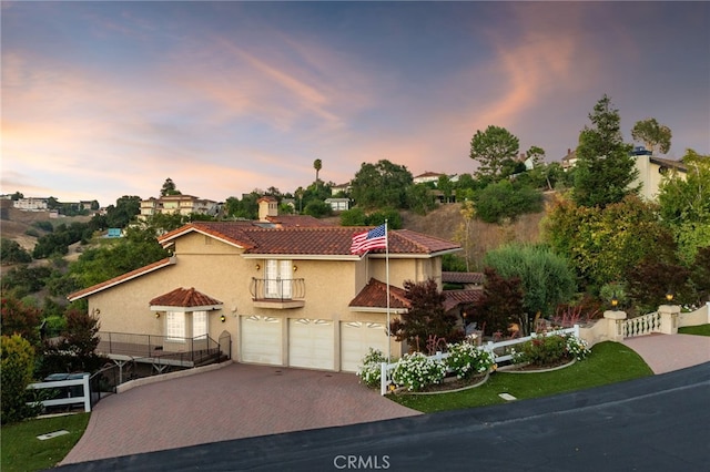 23511 Mirage Ln, Diamond Bar, CA 91765 - mediterranean / spanish home featuring a balcony, decorative driveway, stucco siding, a garage, and a tile roof