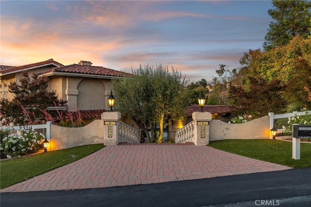 23511 Mirage Ln, Diamond Bar, CA 91765 - mediterranean / spanish house with stairway, a fenced front yard, and stucco siding
