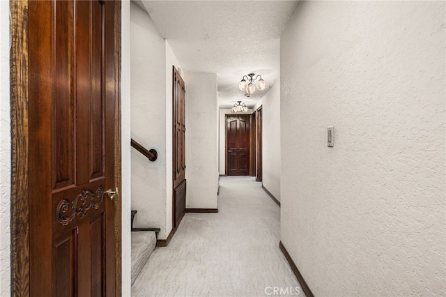 23511 Mirage Ln, Diamond Bar, CA 91765 - hallway featuring a textured wall and light colored carpet