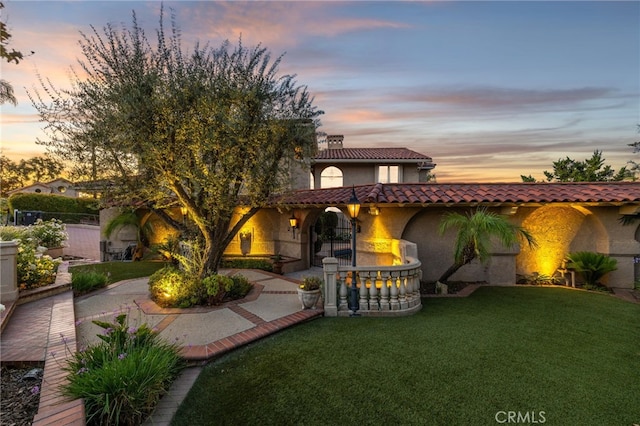 23511 Mirage Ln, Diamond Bar, CA 91765 - mediterranean / spanish-style home with stucco siding, a tiled roof, a lawn, and a chimney