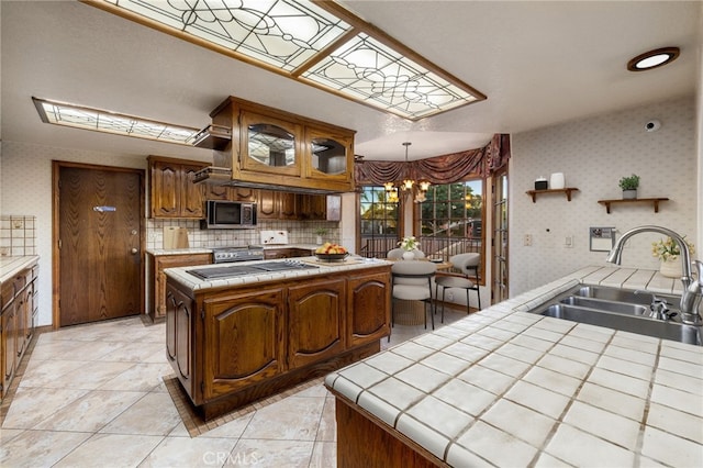 23511 Mirage Ln, Diamond Bar, CA 91765 - kitchen with stainless steel appliances, tile counters, a chandelier, open shelves, and wallpapered walls