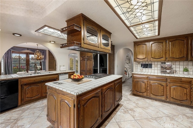 23511 Mirage Ln, Diamond Bar, CA 91765 - kitchen featuring arched walkways, tile countertops, a chandelier, decorative backsplash, and dishwasher