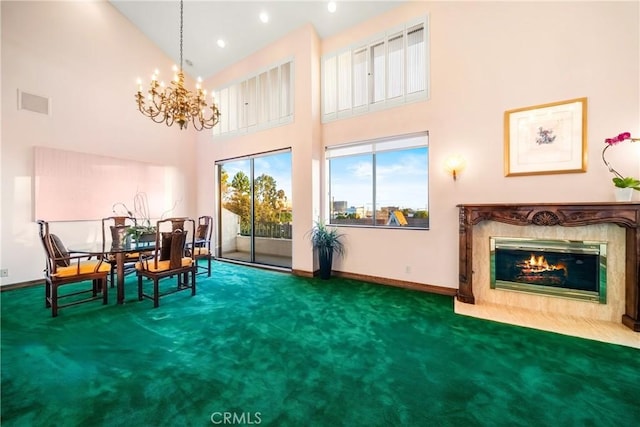 2008 S Bentley Ave Unit 5, Los Angeles, CA 90025 - dining area with carpet, a high ceiling, a chandelier, a fireplace, and recessed lighting