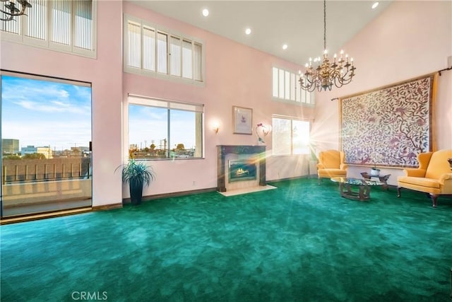 2008 S Bentley Ave Unit 5, Los Angeles, CA 90025 - living area featuring carpet flooring, a towering ceiling, a fireplace, a chandelier, and recessed lighting