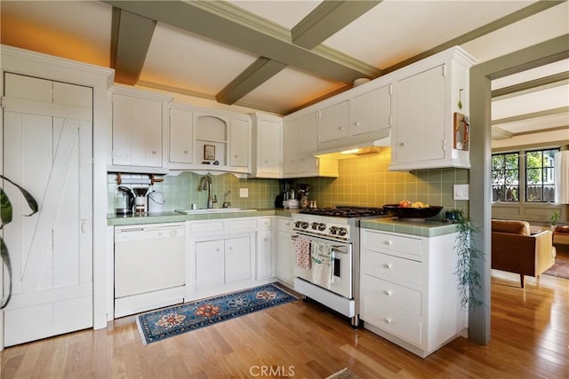 1521 5th St, Los Osos, CA 93402 - kitchen with range with gas stovetop, white dishwasher, under cabinet range hood, beam ceiling, and white cabinetry