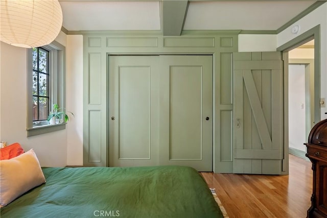 1521 5th St, Los Osos, CA 93402 - bedroom featuring a closet, wood finished floors, ornamental molding, and beam ceiling