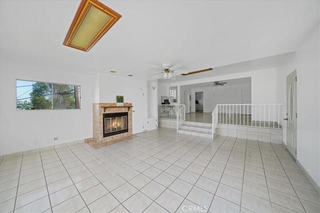 1745 College View Pl, Los Angeles, CA 90041 - unfurnished living room featuring a ceiling fan, light tile patterned floors, and a premium fireplace